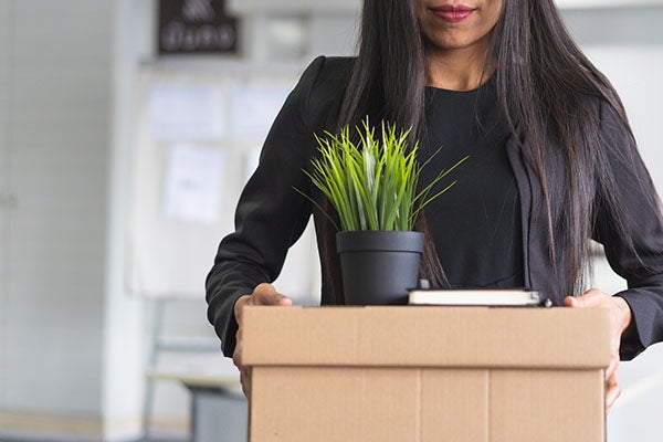 woman holding her personal box of items during a business lay off or retirement