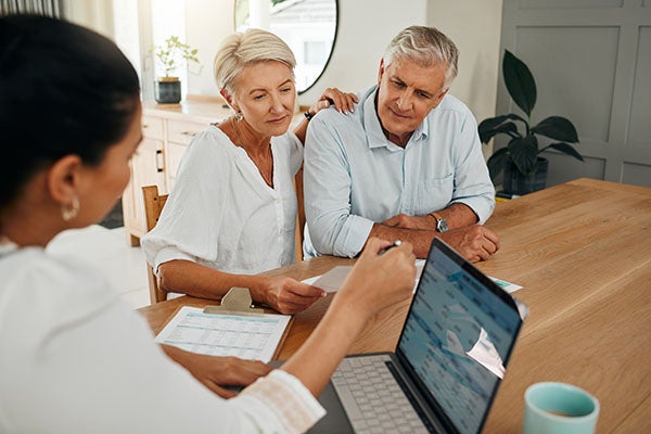 Financial advisor consultation with elderly clients on retirement